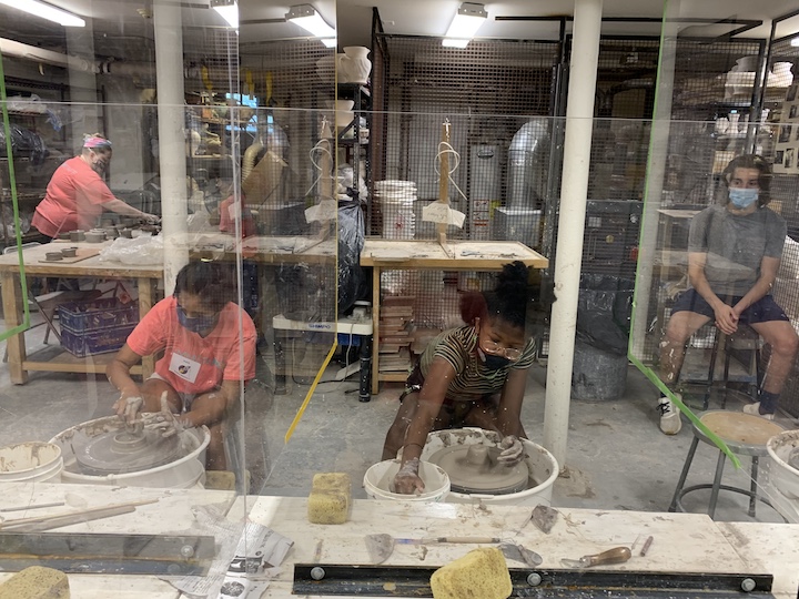Kids and teens throwing on the pottery wheels in MAM's ceramics studio.