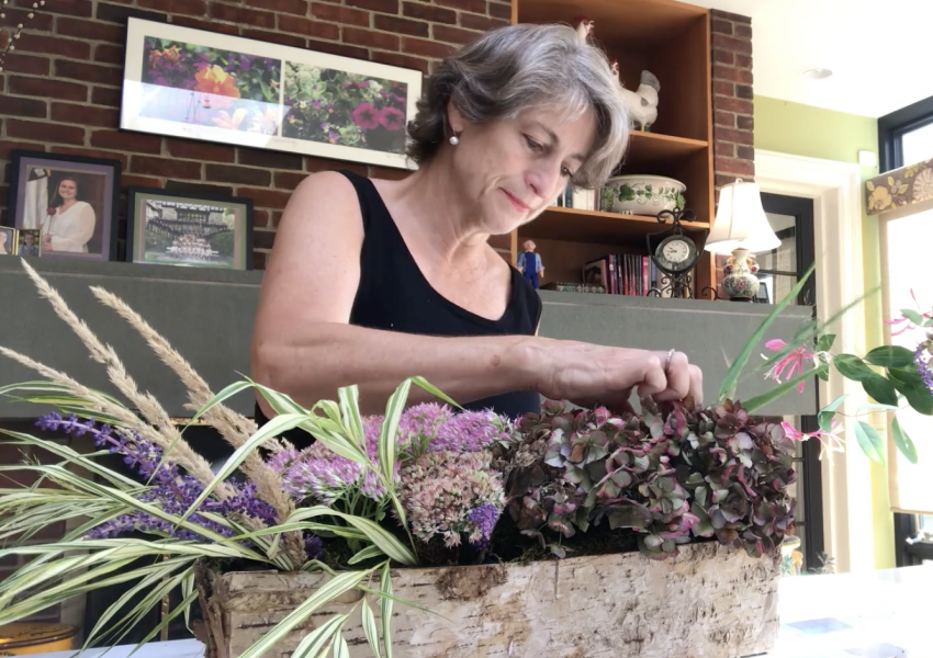 A screenshot of a video of Cynthia Corhan-Aiken sharing her floral design process.