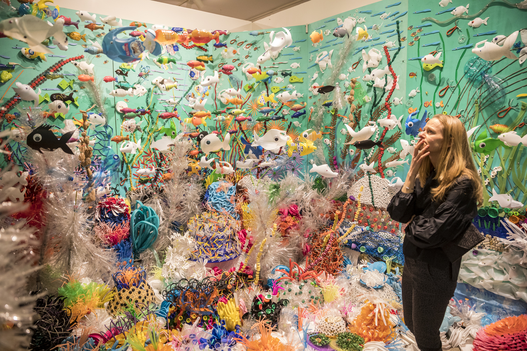 A woman standing in the coral reef installation/
