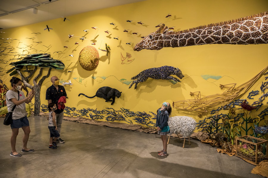 A family is exploring the Federico uribe: animalia exhibition together.