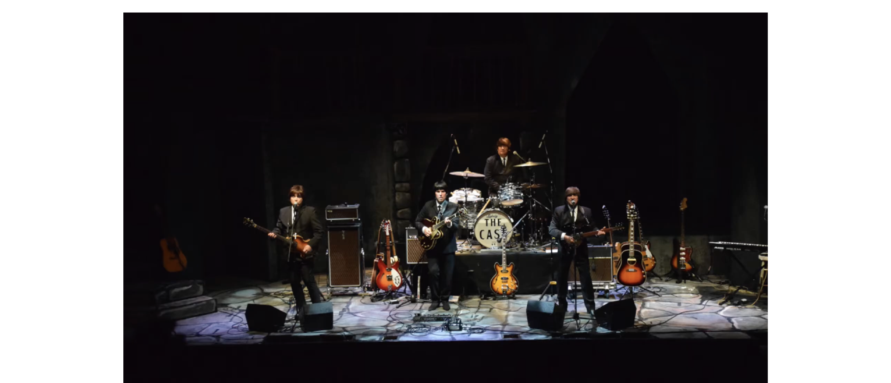 THE CAST OF BEATLEMANIA performing on stage.