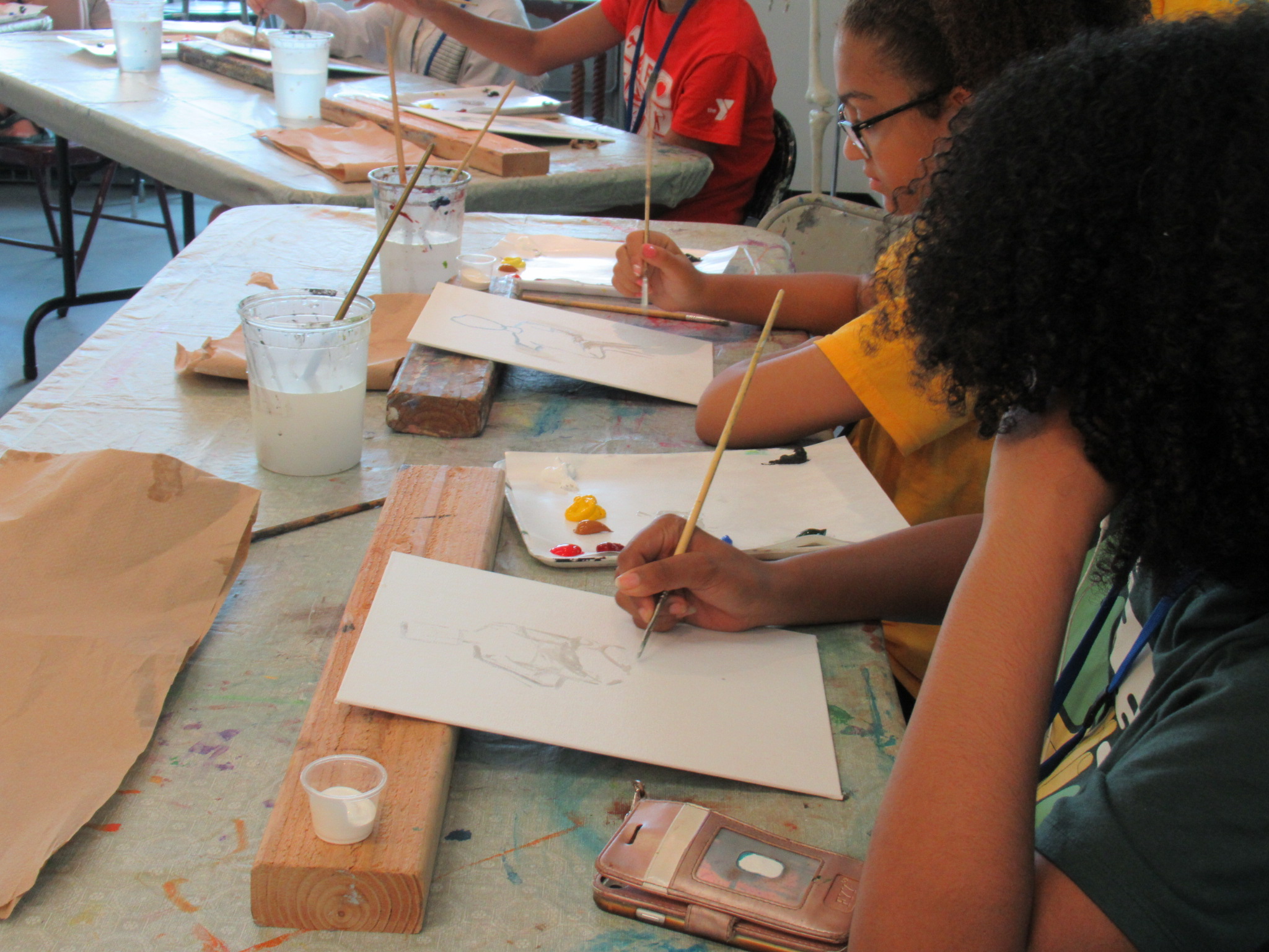 Teens participating in a MAM painting course