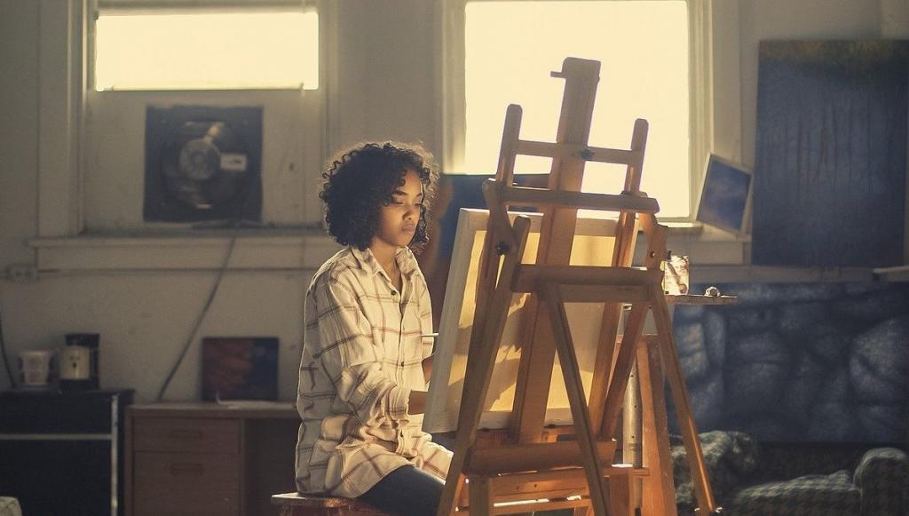 I'm an image! a woman is painting on an easel in a home studio. She is focused on her art and is not looking at the camera.