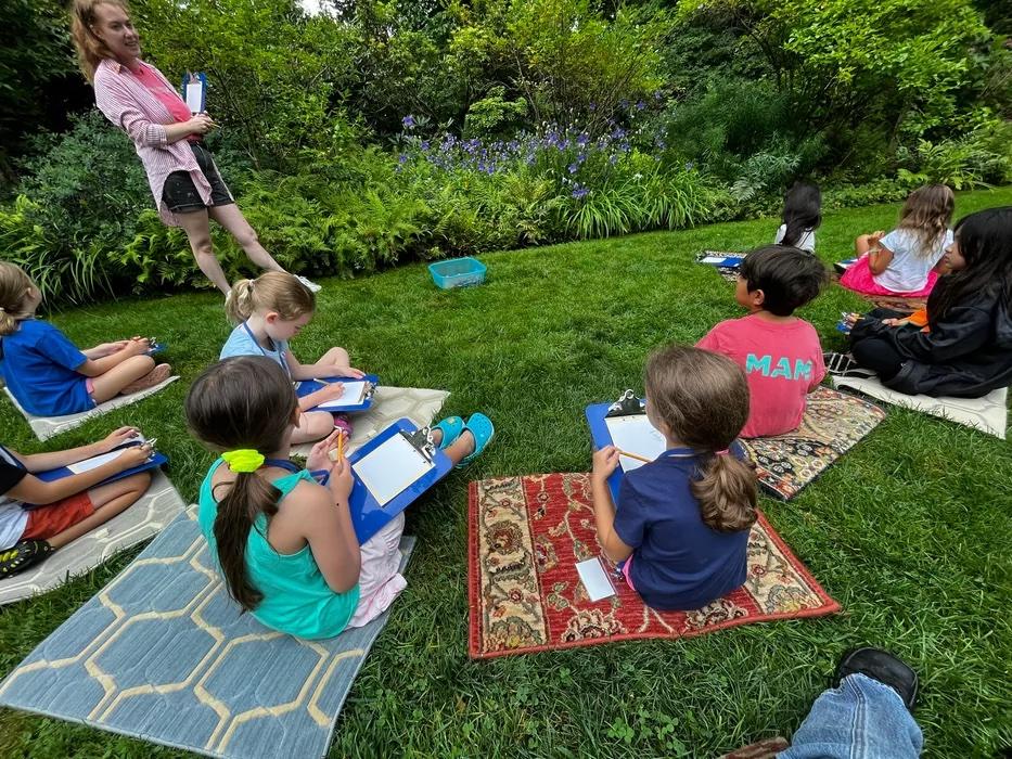 Campers sitting in Van Vleck Gardens drawing as part of SummerART at Van Vleck