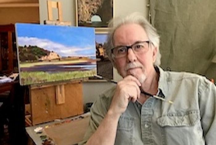 gary godbee sitting next to a canvas in his home painting studio