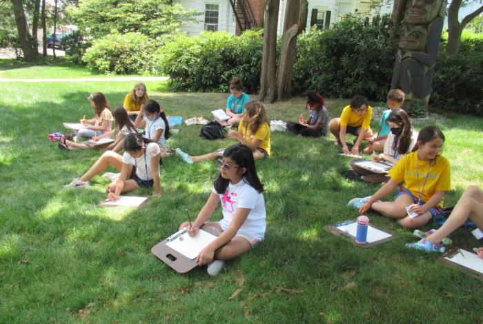 Campers sitting in MAM's grounds drawing as part of SummerART Drawing and Painting: In the Great Outdoors